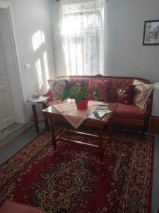 a living room with a couch and a coffee table at Green Housee in Korçë