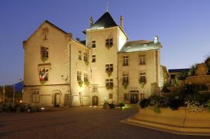 a large white building with lights on it at Hotel ibis budget Aix Les Bains - Grésy in Grésy-sur-Aix