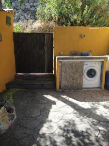 a washing machine is sitting next to a fence at Casa Rural Cottage Bentayga in Tejeda