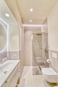 a white bathroom with a shower and a toilet at Il Loft di Quintino in Parma