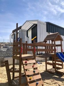 a playground with a bench and a building at Zatoka Marina in Mechelinki