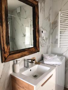 a bathroom with a sink and a mirror at Zatoka Marina in Mechelinki