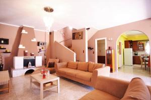 a living room with a couch and a table at Alice Maisonette & Studios in Adamantas
