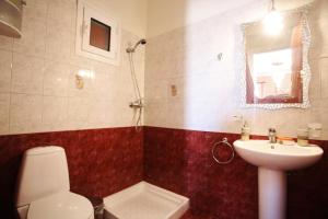 a bathroom with a toilet and a sink at Alice Maisonette & Studios in Adamantas