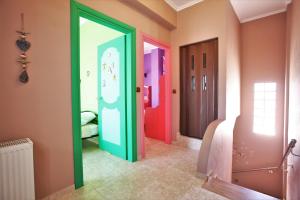 a hallway with colorful doors in a room at Alice Maisonette & Studios in Adamantas