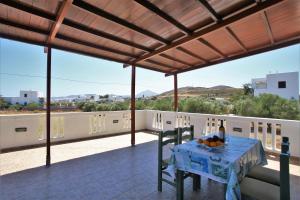 a table on the balcony of a house at Alice Maisonette & Studios in Adamantas