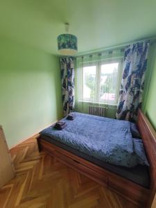 una camera con un letto in una stanza con una finestra di Cozy Sunny Apartment a Gdynia