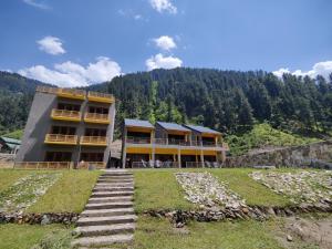 a building on a hill with stairs in front of it at Bela Resorts Naran in Naran