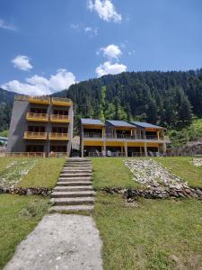 a building with stairs in front of a building at Bela Resorts Naran in Naran