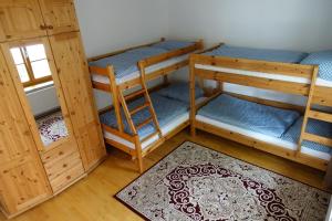 a room with two bunk beds and a rug at Alla in Kittsee