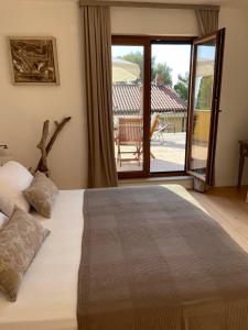 a bedroom with a bed and a sliding glass door at Apartments CLIFF Piran in Piran