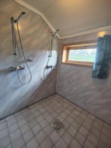 a bathroom with a shower and a window at Kyrkjestølen B&B in Tyinkrysset