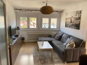 a living room with a couch and a table at Ferienwohnung Frühlingsau in Freudenstadt