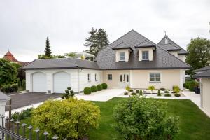 a white house with a black roof at Hüttenzauber & Turmchalet 