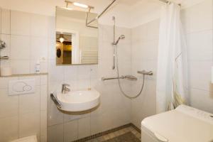 a bathroom with a shower and a sink and a toilet at Lord Nelson in Hörnum +20 photos