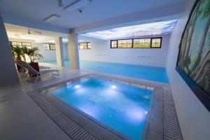 a large indoor swimming pool in a building at Piatra Pinului Ski & Spa in Gura Humorului