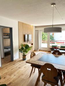 a living room with a wooden table and chairs at Haus Allod 208 in Lenzerheide