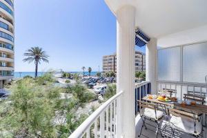 a balcony with a view of the beach and buildings at Sur Suites Astigi Vista Mar in Fuengirola