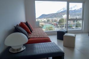 a bedroom with a bed with a view of a mountain at Josefina in Ushuaia