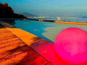 a swimming pool with a pink ball next to the water at Villa Argento Relais in Bagheria