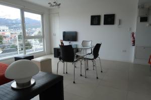 a living room with a table and chairs and a television at Josefina in Ushuaia