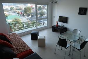 a living room with a couch and a glass table at Josefina in Ushuaia