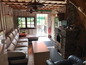 a living room with a couch and a fireplace at Nõlva Holiday Home in Tammiste