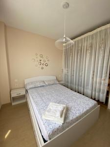 sypialnia z łóżkiem i żyrandolem w obiekcie Apartamento Primera Linea de Playa w mieście Oropesa del Mar