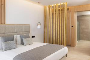 a bedroom with a large bed and a sliding glass door at Atlantica Bay - Adults Only in Limassol