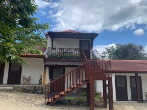 a house with a staircase in front of it at Estabulo de Valinhas in Vitorino dos Piães