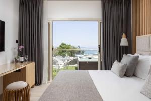 a bedroom with a bed and a view of the ocean at Atlantica Bay - Adults Only in Limassol +37 photos