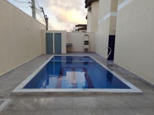 a blue swimming pool on the roof of a house at TAPERAPUAN in Porto Seguro