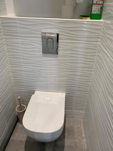 a bathroom with a white toilet in a stall at WINNIE Studio indépendant trés proche de DISNEY Paris in Chessy