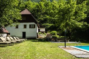 a backyard with a pool and a house at Gorska Vila mountain villa in Soča
