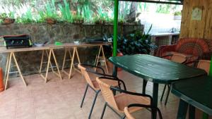 a green table and chairs in a patio with a table at Casa Rural: La Casa Mágica de Gredos in Madrigal de la Vera