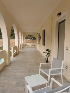 a hallway with chairs and tables in a building at Villa Bianca in Chia