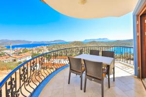 a balcony with a table and chairs and a view at Nirvana Apartments in Kas