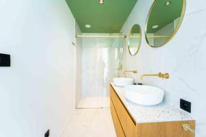a bathroom with two sinks and a mirror at SPA & Garden - Luxury Private Apart' Mons Center in Mons