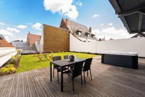 a wooden deck with a table and chairs on a house at SPA & Garden - Luxury Private Apart' Mons Center in Mons