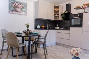 a kitchen with a table and chairs and a dog at Sangalo apartment in Trogir