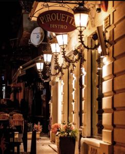 an alley with lights and a sign on a building at Belle Epoque Boutique (Adult Only) in Constanţa