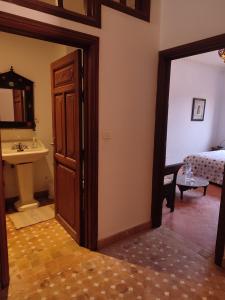 a room with a door and a sink and a bed at Imsouane Surf Paradise in Imsouane