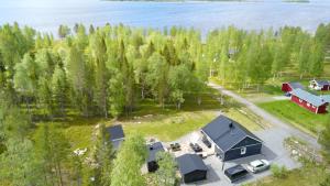 an aerial view of a house with a garage and a lake at The Novac's Cottage in Råneå