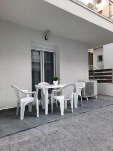 un tavolo bianco e sedie su un patio di By the sea a Perea