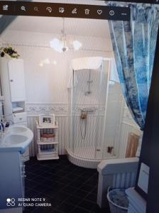 a bathroom with a tub and a sink at La Gravière 