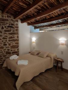 a bedroom with a bed with two towels on it at masia riu dels arbres in Benasal