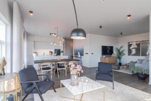 a living room with a table and chairs at Ocean Breeze Luxury Apartment in Reykjavík