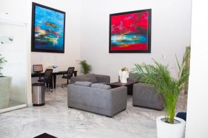 a living room filled with furniture and a painting at Holiday Inn Express Guaymas, an IHG Hotel in Guaymas