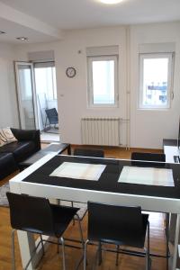 a living room with a table and chairs at Vanja’s place in Dušanovac (historical)