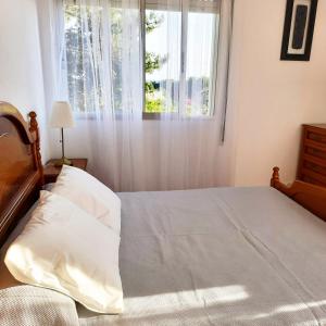Posteľ alebo postele v izbe v ubytovaní Apartamentos Mar de Nanín
